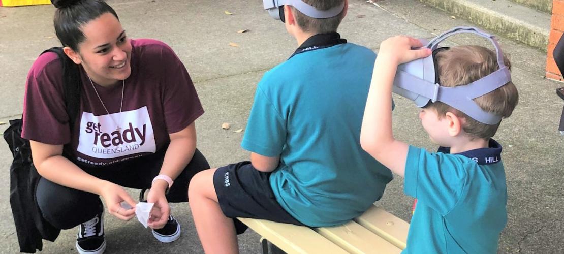 Person talking to two kids playing virtual reality game